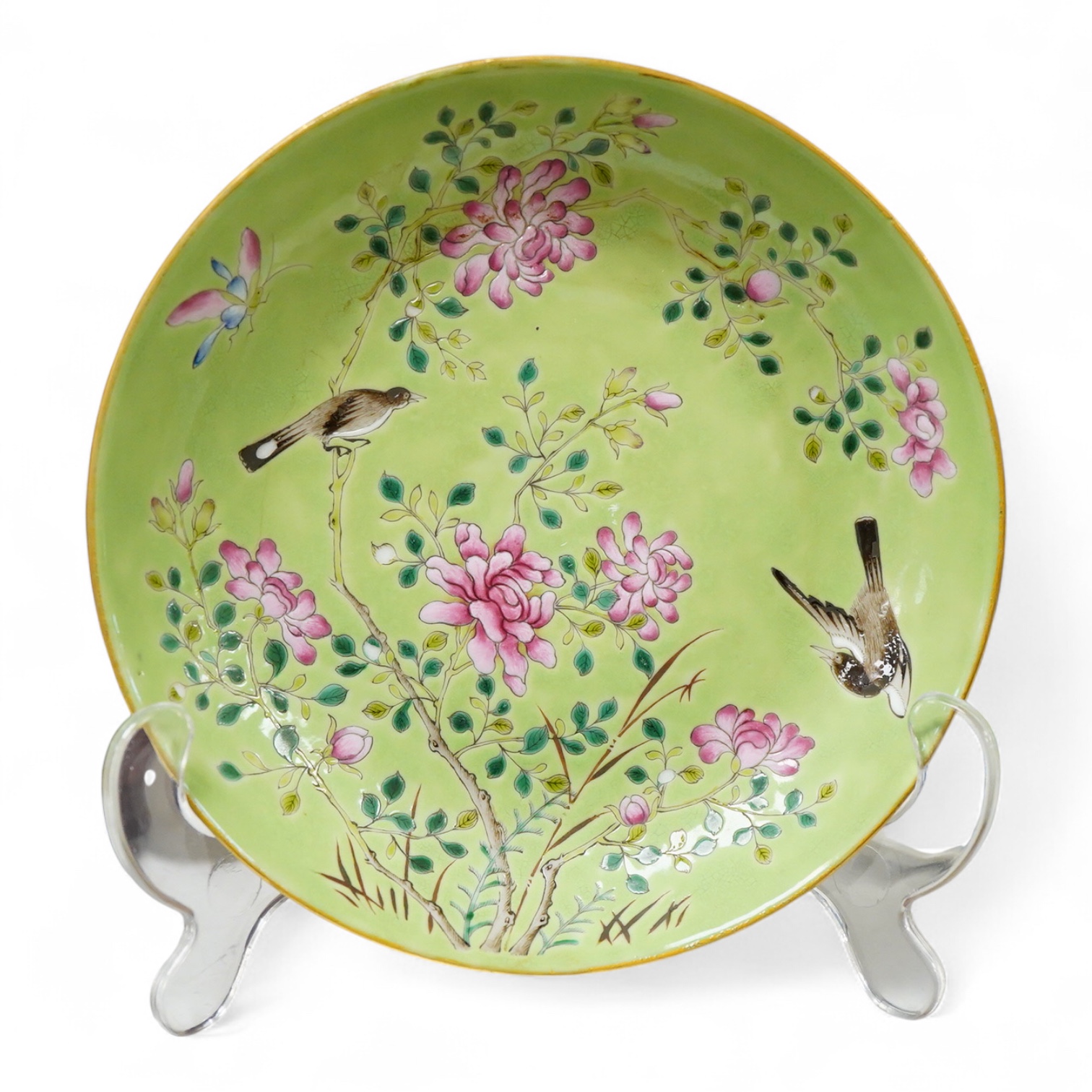 A Chinese famille rose and green ground dish decorated with birds amongst flowers, 17cm in diameter